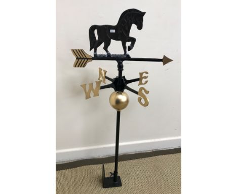 A painted cast iron weather vane with horse surmount