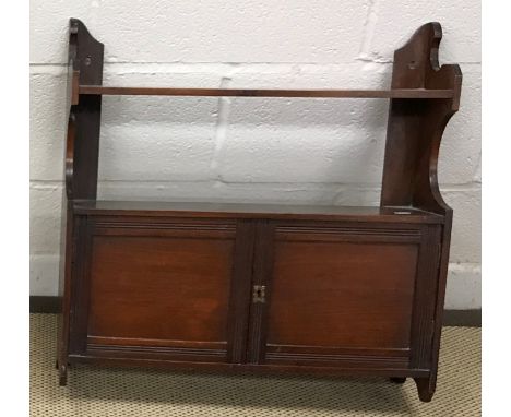 An Edwardian mahogany fire guard, with three glass panels, the centre panel sliding up, on splayed supports united by a leath