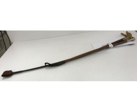 A vintage riding crop with plaited shaft and white metal ferrule, with dog's head finial 70 cm long together with a cane shaf