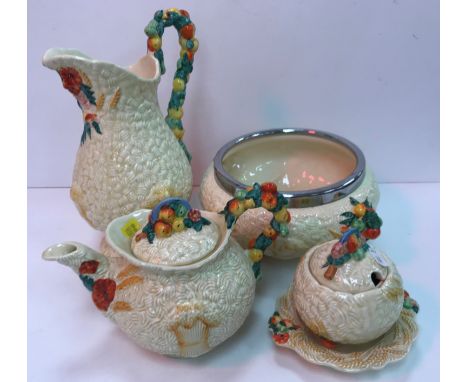 A collection of five pieces of Clarice Cliff Newport Pottery Celtic harvestware including baluster jug 27.5 cm high, chrome f