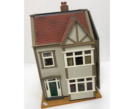 A late 20th Century dolls house with fitted interior together with a further late 20th Century dolls house as an Art Deco hou