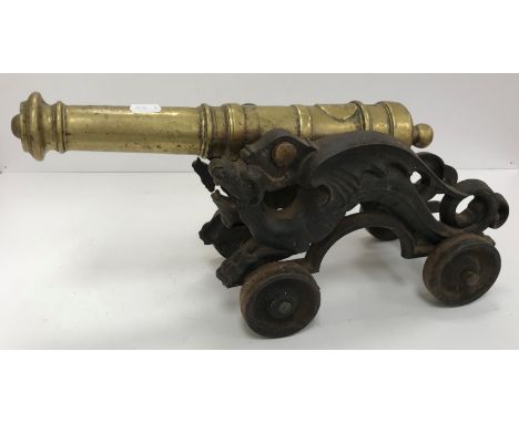 A circa 1900 bronze canon on cast iron wyvern or dragon decorated carriage 45 cm long x 16 cm wide 
