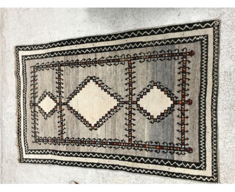 A Caucasian rug, the central panel set with four medallions on a mushroom ground within a stepped mushroom and dark brown geo
