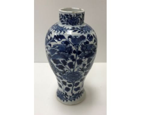 A 19th Century Chinese blue and white baluster shaped vase decorated with four toed dragons  amongst blossoming foliage beari