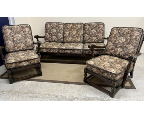 An Ercol elm framed three piece cottage living room suite comprising sofa and two armchairs 160 cm wide x 90 cm deep x 82 cm 