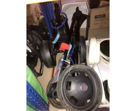 A collection of golfiing equipment to include compact trolleys, bags, etc.