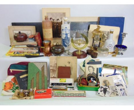 Two leather suitcases filled with miscellaneous items to include a cast metal egg timer, various glassware and porcelain.
