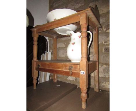 A Victorian stripped and waxed pine wash stand, with ceramic jug and basin