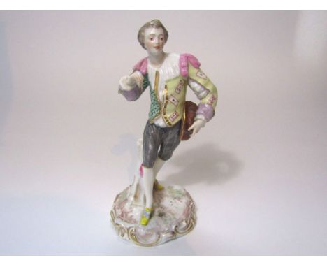 An early 19th century Derby figure of male character in 18th century style costume, his jacket decorated with playing cards t