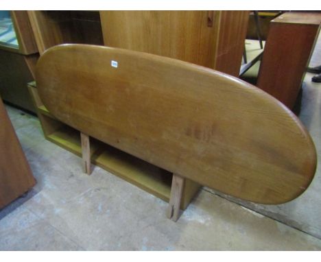 An Ercol light elm headboard, 143 cm long approx.