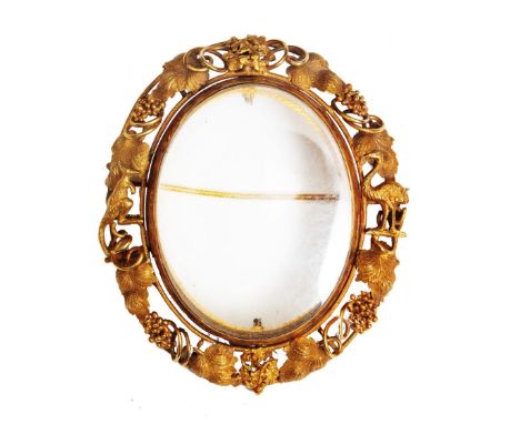 An Australian portrait brooch with openwork frame interspersed by grape vines and applied kangaroo and emu figures, possibly 