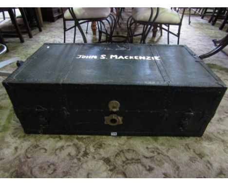 An Edwardian travelling trunk and canvas with steel banded borders with partially fitted interior