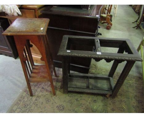 An oak two divisional stick stand with carved detail together with an oak plant stand