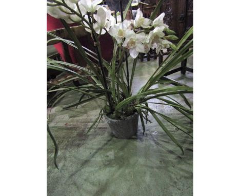 A simulated flowering orchid in a ceramic pot