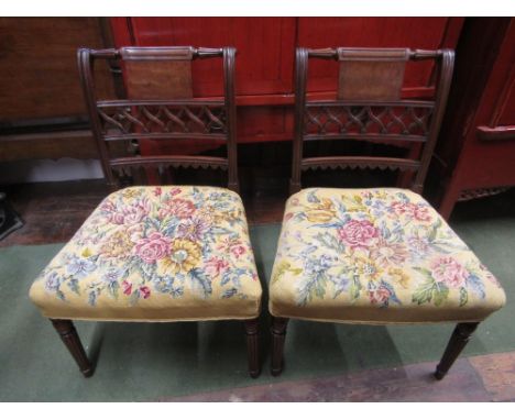 A good pair of George III mahogany side chairs on turned and fluted supports, carved and moulded backs and handworked floral 
