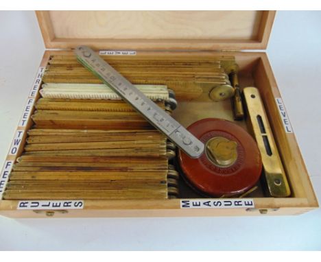 A box containing a large collection of articulated rulers and measuring tools together with spirit levels and others.