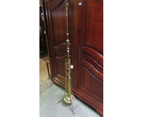 An Art Nouveau polished brass lamp standard with adjustable column adapted for electricity