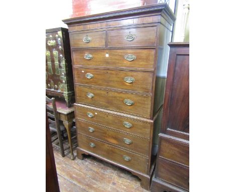 A George III mahogany chest on chest, six long and two short graduated drawers beneath a dentil frieze, raised on bracket sup