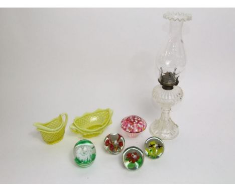 Five various glass paperweights together with two vaseline glass pieces to include a milk jug and twin handled bowl and a fur