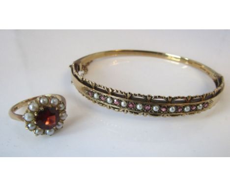 A 9ct hinged bangle set with garnets and seed pearls, together with a 9ct almandine garnet ring, size J/K, 16.5g total