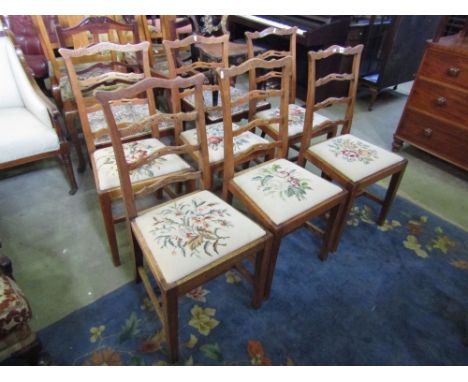 A set of six Edwardian cottage ladderback chairs in oak with individually hand worked tapestry seats on square cut supports