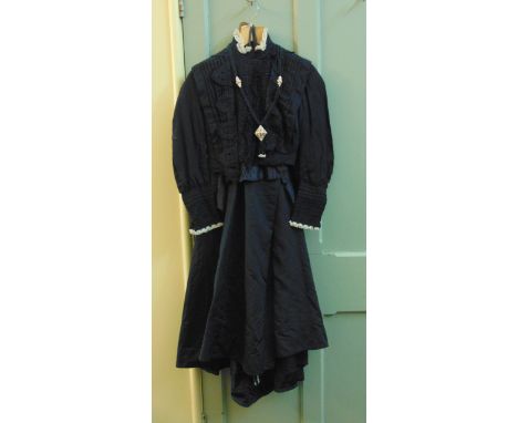 A late 19th century black two piece ladies mourning costume (with some later modifications) comprising a blouse with pin-tuck