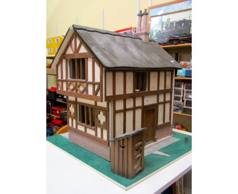 Scale model dolls house in the mock Tudor manner together with a small quantity of furniture