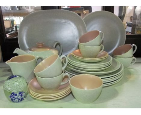 A collection of Poole pottery wares with coloured interiors and mottled cream glaze comprising tea pot, milk jug, sugar bowl,