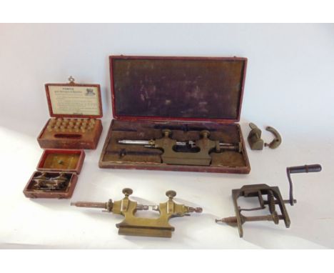 A box containing a selection of antique watchmakers precision tools.