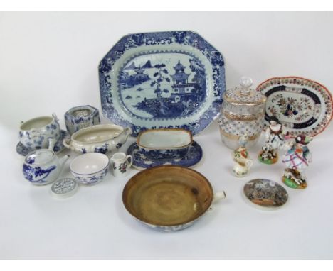 A 19th century oriental blue and white meat plate with pagoda and fishing boat decoration, 40cm long together with a similar 