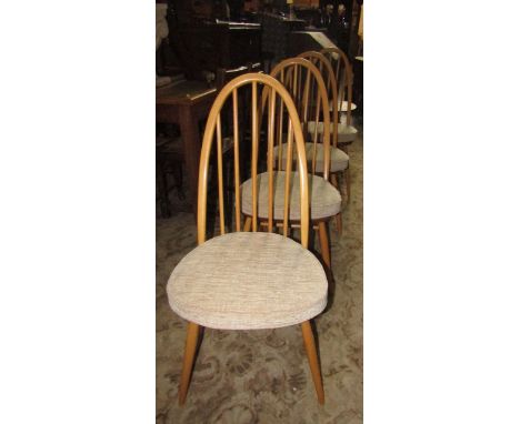 A set of four Ercol light elm Windsor dining chairs.