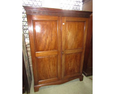 A good quality Edwardian mahogany hanging cupboard in the Georgian style, enclosed by a pair of fielded panelled doors beneat