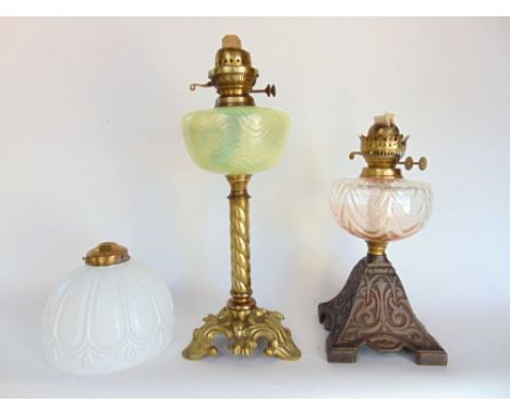 A good quality cast brass oil lamp with vaseline glass reservoir, barley twist column and Rococo type base together with a fu