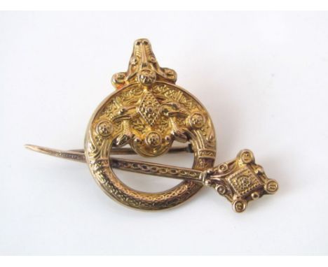 A 9ct gold brooch with embossed decoration in the form of a Celtic cloak pin, 4.5g