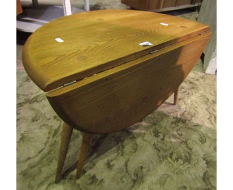 An Ercol light elm drop leaf coffee table.