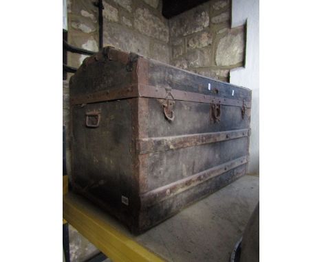 A late 19th century travelling trunk with domed top with timber lathes