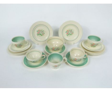 A collection of Susie Cooper tea wares in the Dresden pattern with printed floral sprays comprising five cups, five saucers, 