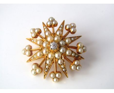 A seed pearl and diamond brooch/pendant with dual fitting of starburst design, in unmarked yellow metal, 5.5g