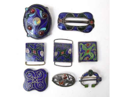 A collection of eight Arts & Crafts enamelled brooches and buckles with celtic and other detail
