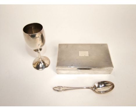 A mixed collection of silver to include an engine turned cigarette box, silver goblet and further silver dessert spoon (3)