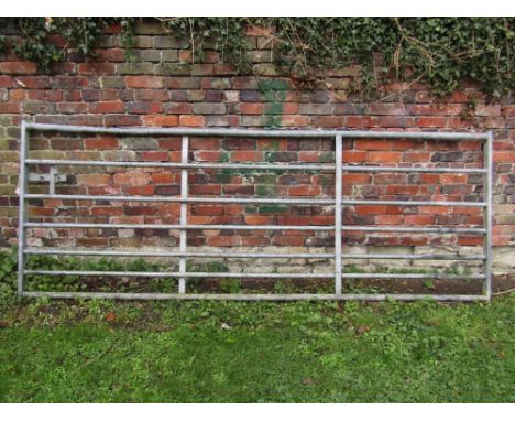 A galvanised iron field gate, 3 metres in length