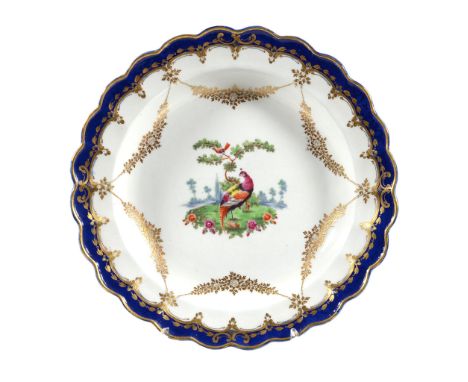  A Worcester plate,   circa 1775, the centre painted with a úncy bird', within a blue-band and gilt border of C-scrolls suspe