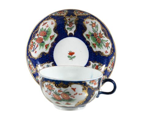  A Worcester blue-scale-ground 'Kakiemon' teacup and saucer,   circa 1770, decorated with a version of the 'Rich Kakiemon' pa