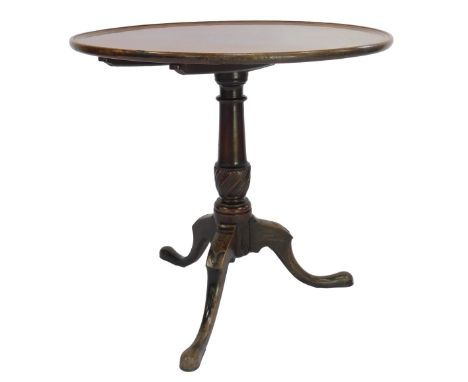 A George III mahogany tilt top table, the circular dish top on a part turned column, on shell carved tripod base with pad fee