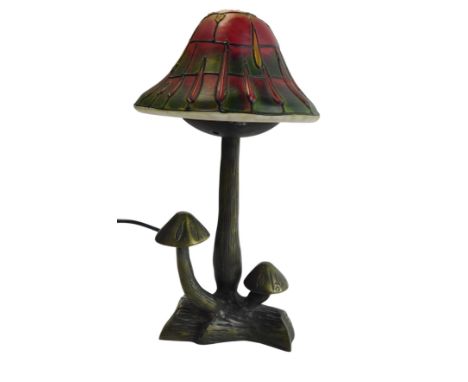 A Tiffany style table lamp, modelled as a mushroom, with a coloured glass shade, with two further mushrooms to the base, 31.5
