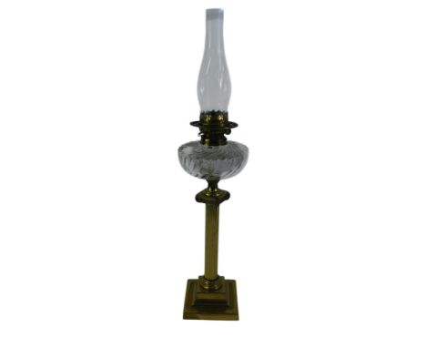 A late 19th/early 20thC Youngs brass oil lamp, with a fluted clear glass central reservoir, raised on a brass ionic column, o