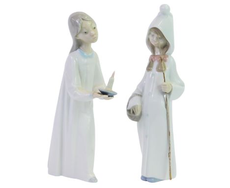 Two Lladro porcelain figures, modelled as a young girl wearing a nightdress, holding a chamberstick, 20cm high, together with