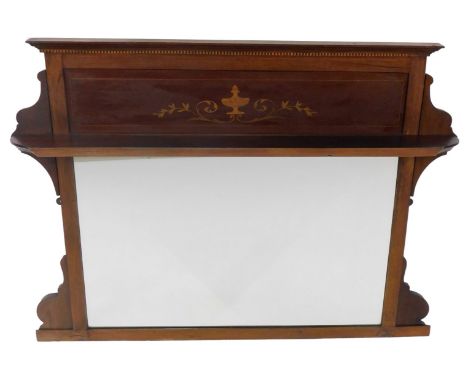 An Edwardian mahogany and inlaid overmantel mirror, the top with a moulded cornice above an urn and foliate scroll panel, wit