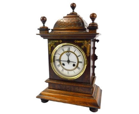 A late 19thC oak and walnut cased mantel clock, the circular white enamel dial bearing Roman numerals, eight day movement, th