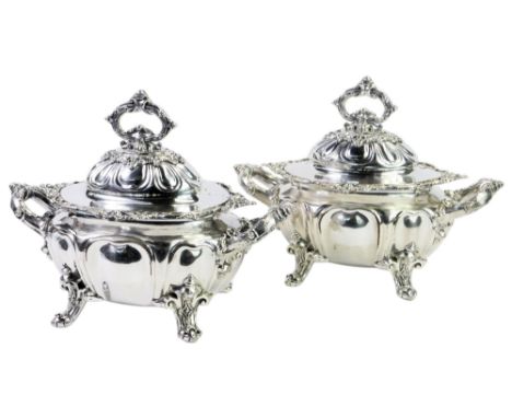 A pair of Victorian silver plated twin handled lidded sauce tureens, each of part fluted form profusely decorated with scroll